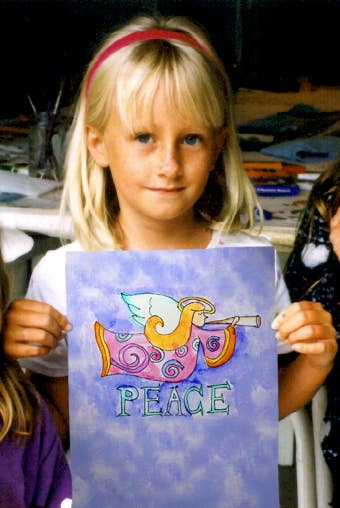 Lauren Van Woy, Age 7 holding her original Peace Angle watercolor